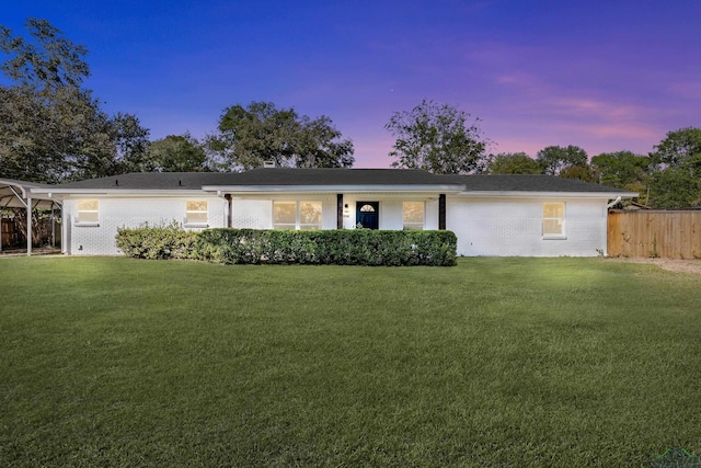 ranch-style home featuring a yard