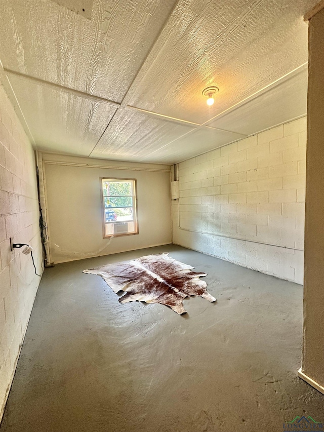 unfurnished room featuring concrete flooring