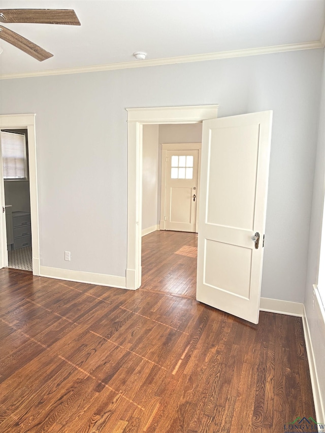 unfurnished room featuring ceiling fan, dark hardwood / wood-style floors, and ornamental molding