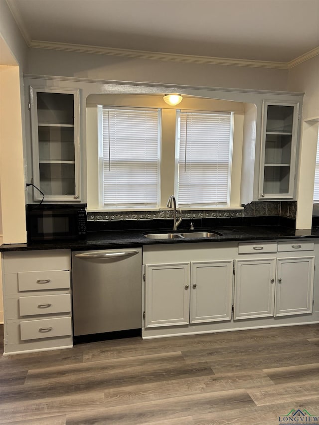 kitchen with stainless steel dishwasher, crown molding, white cabinets, and sink