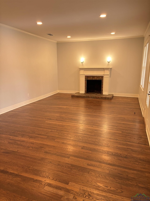 unfurnished living room with a fireplace, dark wood-type flooring, and crown molding