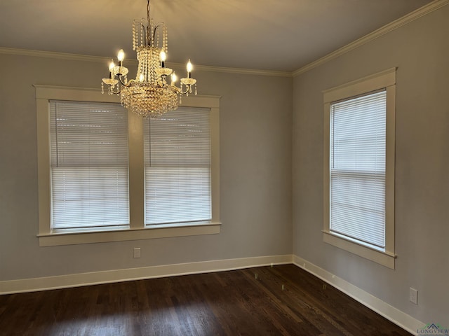 unfurnished dining area featuring dark hardwood / wood-style floors, a healthy amount of sunlight, ornamental molding, and an inviting chandelier