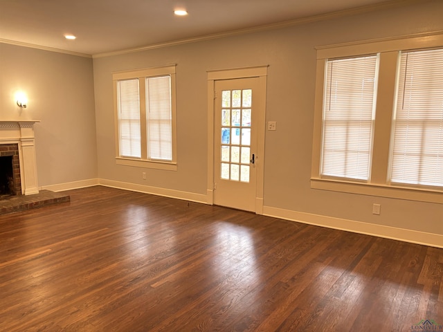 unfurnished living room featuring dark hardwood / wood-style flooring, a fireplace, and ornamental molding