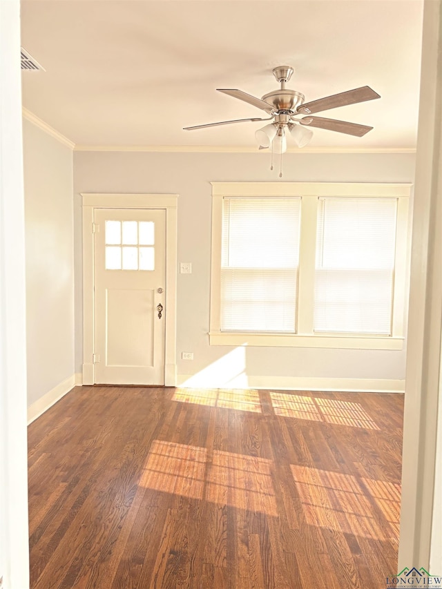 entryway featuring ceiling fan, ornamental molding, and dark wood-type flooring