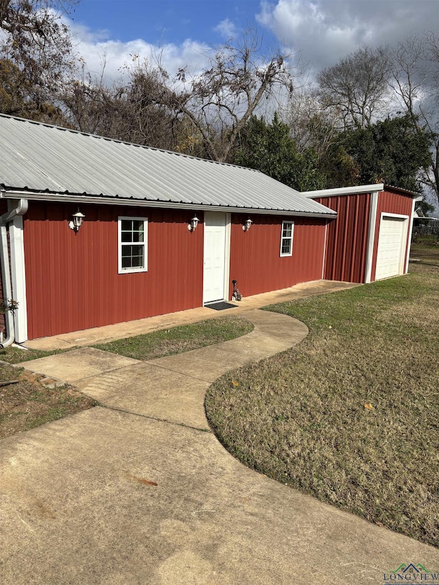 view of outdoor structure with a yard and a garage