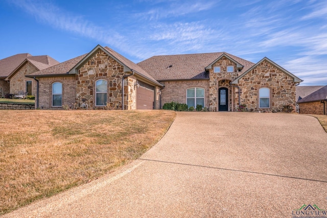 view of front facade with a front lawn and a garage