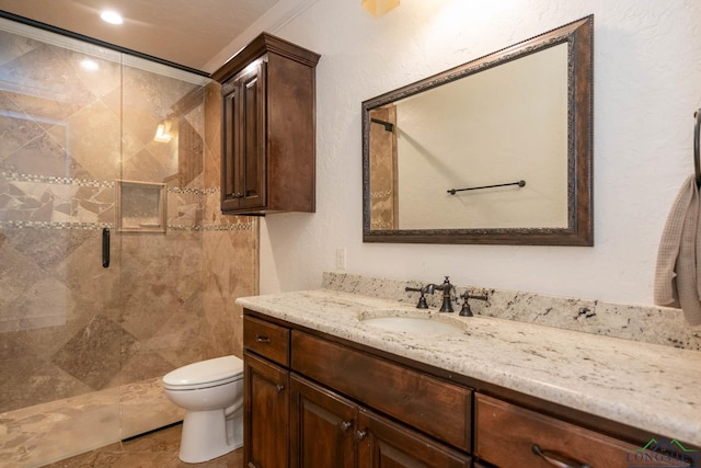 bathroom with vanity, tile patterned floors, toilet, ornamental molding, and walk in shower