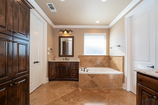 bathroom featuring vanity, crown molding, and tiled tub