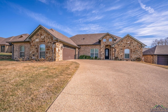 view of front facade with a garage and a front yard