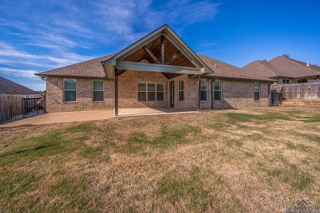 rear view of property with a patio area and a lawn