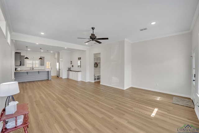 living room with crown molding, light hardwood / wood-style flooring, and ceiling fan