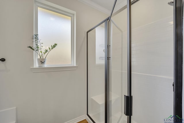 bathroom featuring crown molding and an enclosed shower