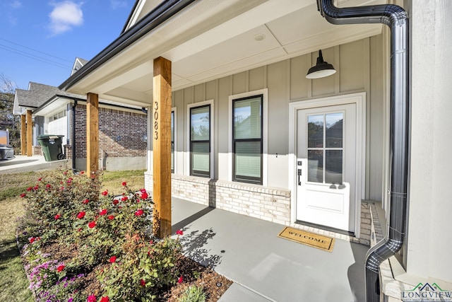 view of exterior entry with a porch