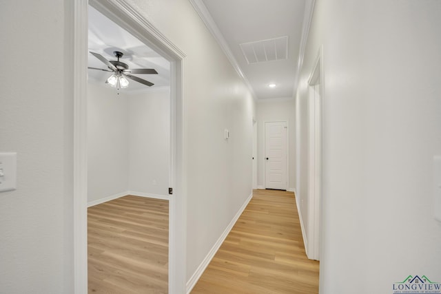 hall featuring crown molding and light hardwood / wood-style flooring