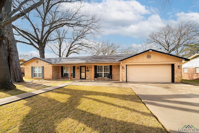 ranch-style house featuring a front yard, a garage, and a porch