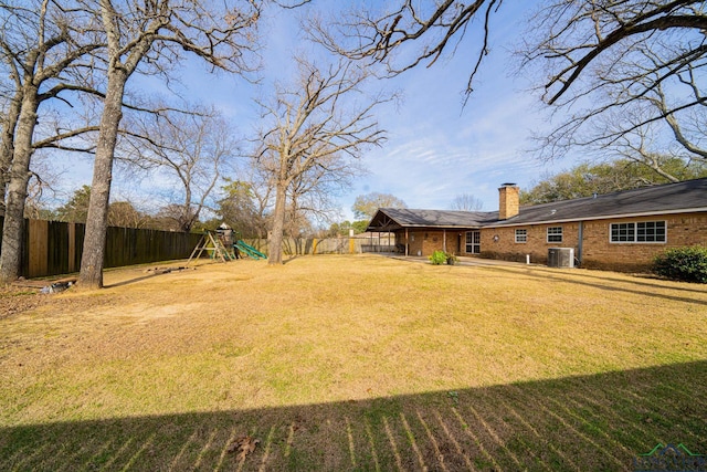 view of yard featuring central AC and a playground