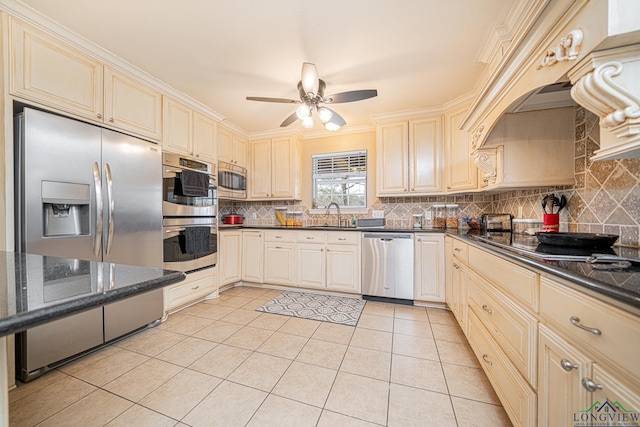 kitchen featuring appliances with stainless steel finishes, ceiling fan, backsplash, and light tile patterned flooring