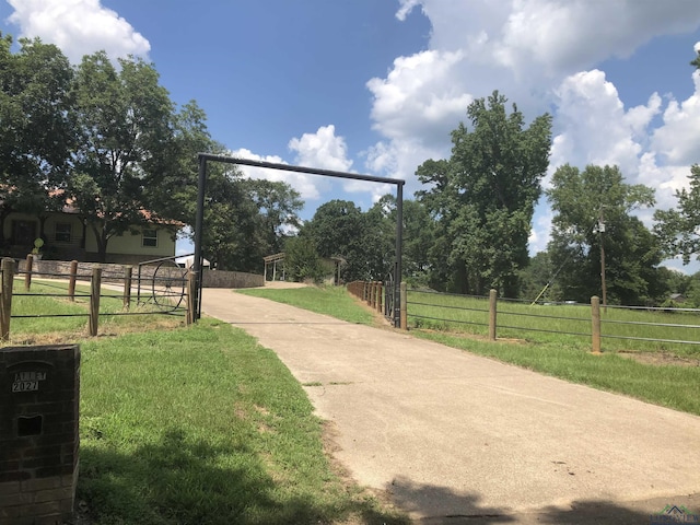 surrounding community with a yard and a rural view