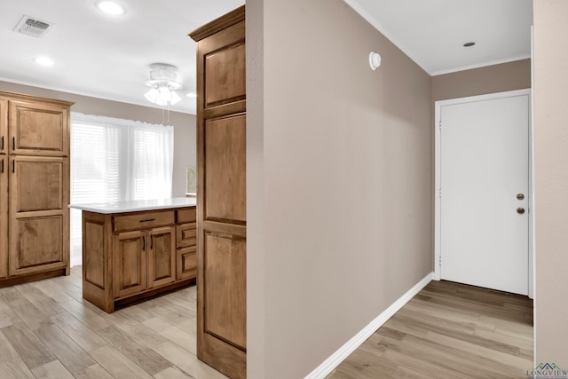 hall featuring light wood-type flooring and ornamental molding