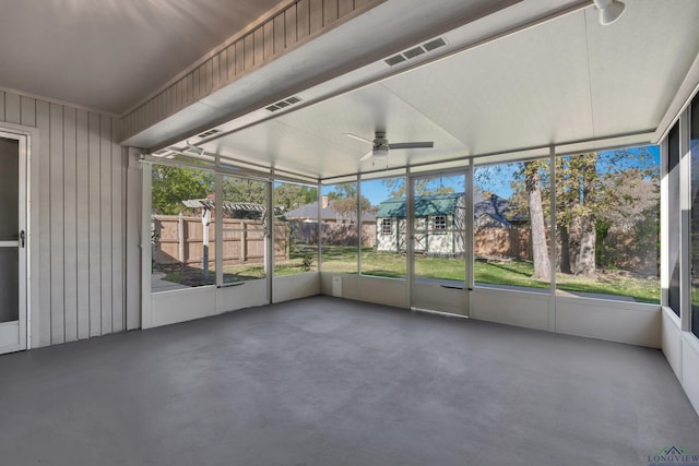 unfurnished sunroom with ceiling fan