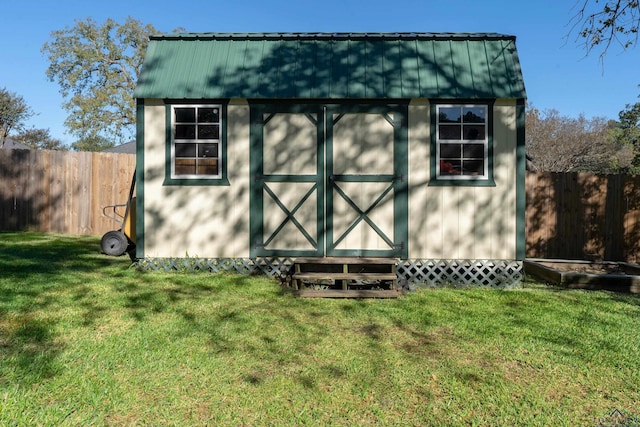 view of outdoor structure featuring a lawn