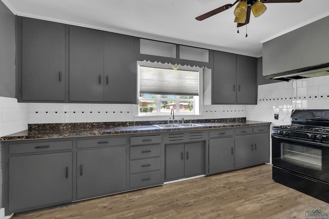 300 Hailey Dr, Longview, TX 75602 - kitchen with black range with gas stovetop, a sink, and gray cabinetry