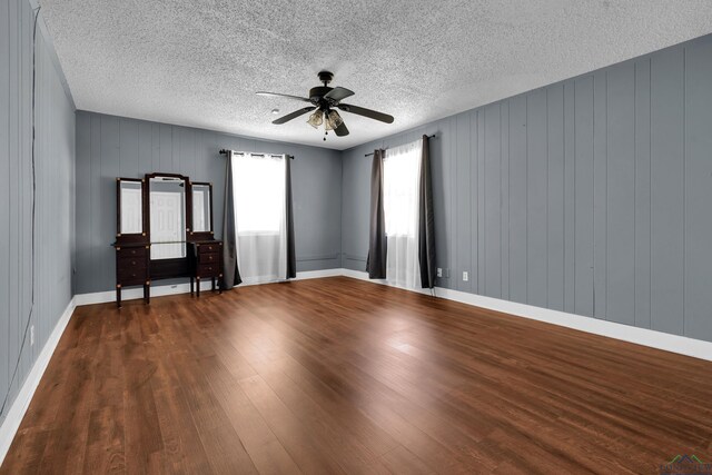 300 Hailey Dr, Longview, TX 75602 - empty room featuring a ceiling fan, wood finished floors, a textured ceiling, and baseboards