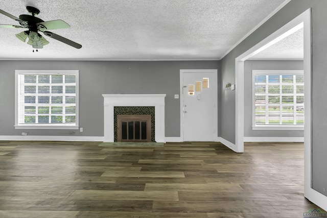 300 Hailey Dr, Longview, TX 75602 - unfurnished living room featuring a textured ceiling, wood finished floors, a ceiling fan, baseboards, and a glass covered fireplace