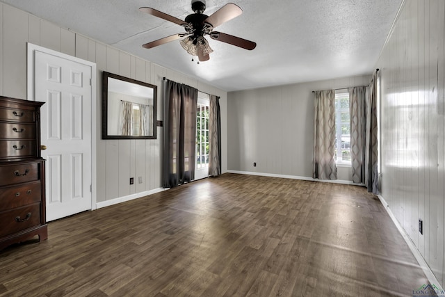 300 Hailey Dr, Longview, TX 75602 - spare room featuring wood finished floors, healthy amount of natural light, ceiling fan, a textured ceiling, and baseboards
