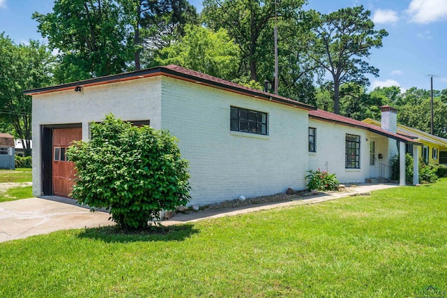 300 Hailey Dr, Longview, TX 75602 - view of property exterior with a chimney, a yard, and brick siding