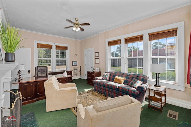 carpeted living room featuring ceiling fan, crown molding, plenty of natural light, and a fireplace