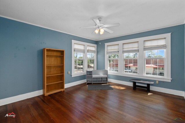 unfurnished room with ceiling fan, crown molding, and dark wood-type flooring