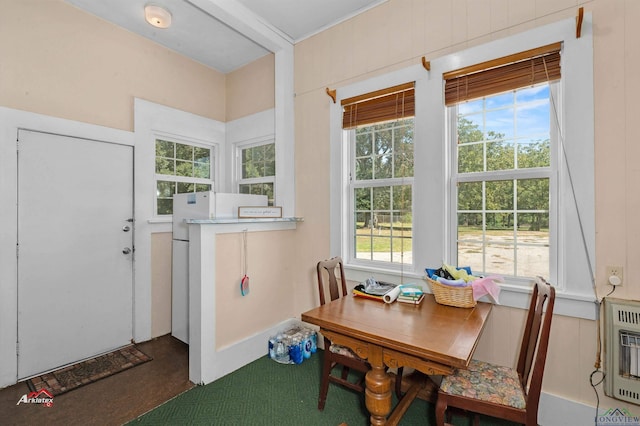 sunroom / solarium with heating unit and a wealth of natural light