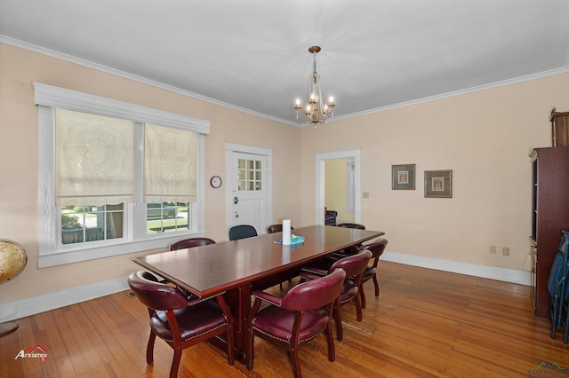 dining space featuring hardwood / wood-style flooring, ornamental molding, and a chandelier