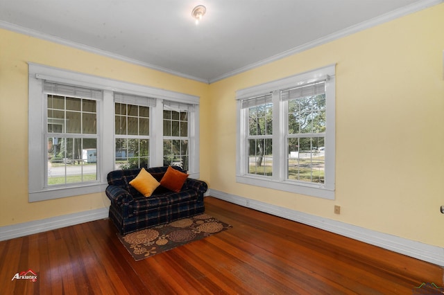 living area with hardwood / wood-style floors and ornamental molding