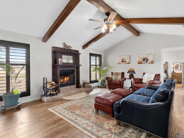 living room with hardwood / wood-style floors, lofted ceiling with beams, and ceiling fan