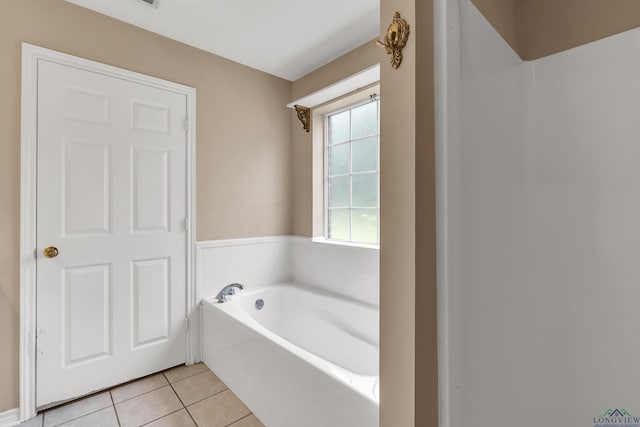 bathroom featuring tile patterned floors and a bathing tub