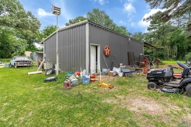 view of outbuilding with a yard