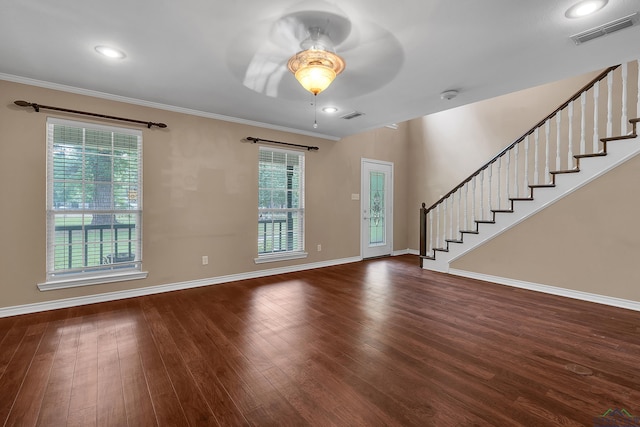 interior space with ceiling fan, dark wood-type flooring, a healthy amount of sunlight, and ornamental molding