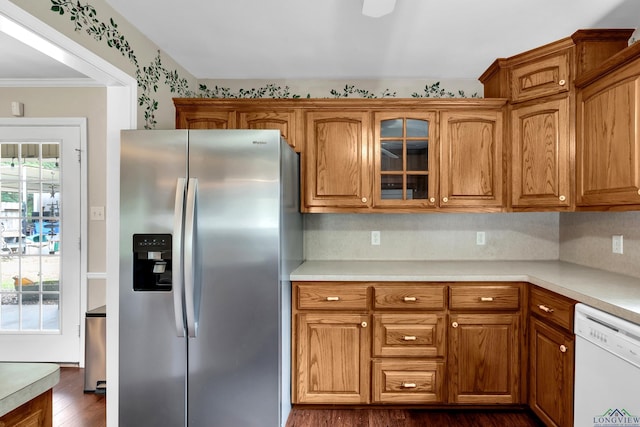 kitchen featuring white dishwasher, crown molding, decorative backsplash, dark hardwood / wood-style flooring, and stainless steel fridge with ice dispenser