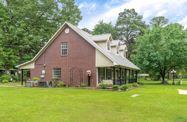 view of side of home with central AC unit and a lawn