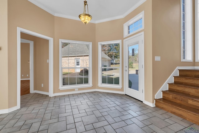 foyer featuring a wealth of natural light and crown molding