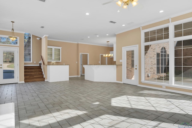 unfurnished living room with ceiling fan with notable chandelier and crown molding