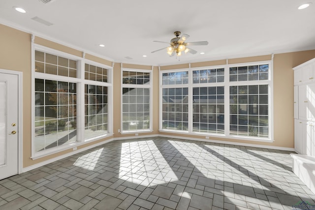 unfurnished sunroom with ceiling fan