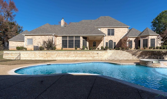 view of pool with an in ground hot tub