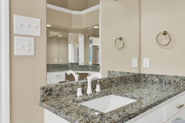 bathroom featuring vanity and ornamental molding