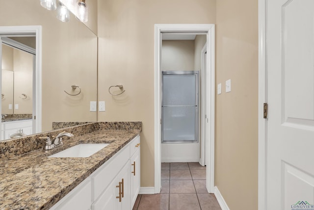 bathroom with enclosed tub / shower combo, tile patterned floors, and vanity