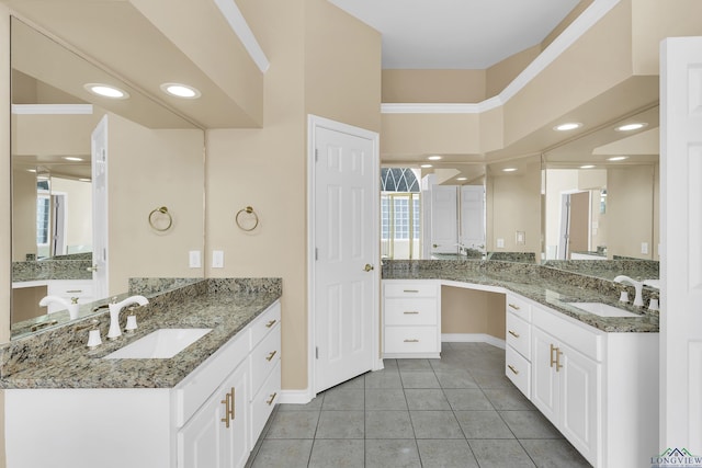 bathroom featuring tile patterned flooring, a towering ceiling, and vanity