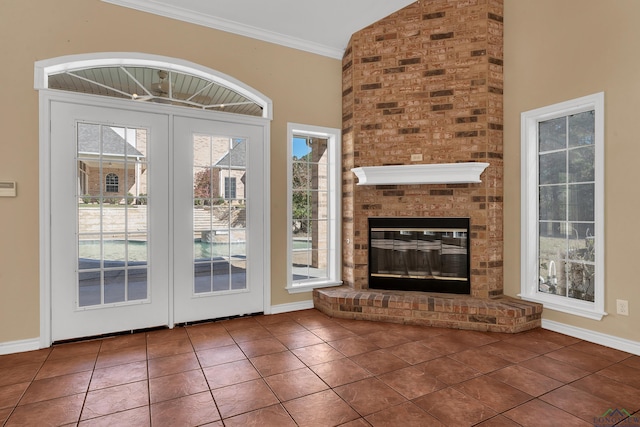 doorway with lofted ceiling, tile patterned flooring, a fireplace, and plenty of natural light