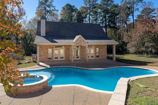 view of pool with an in ground hot tub, a patio area, and french doors